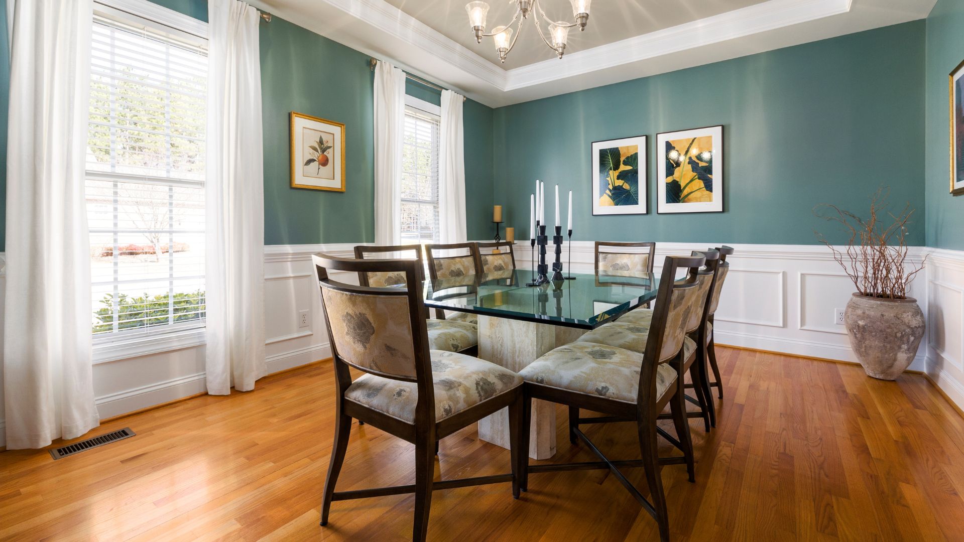 A dining room with a glass table and chairs