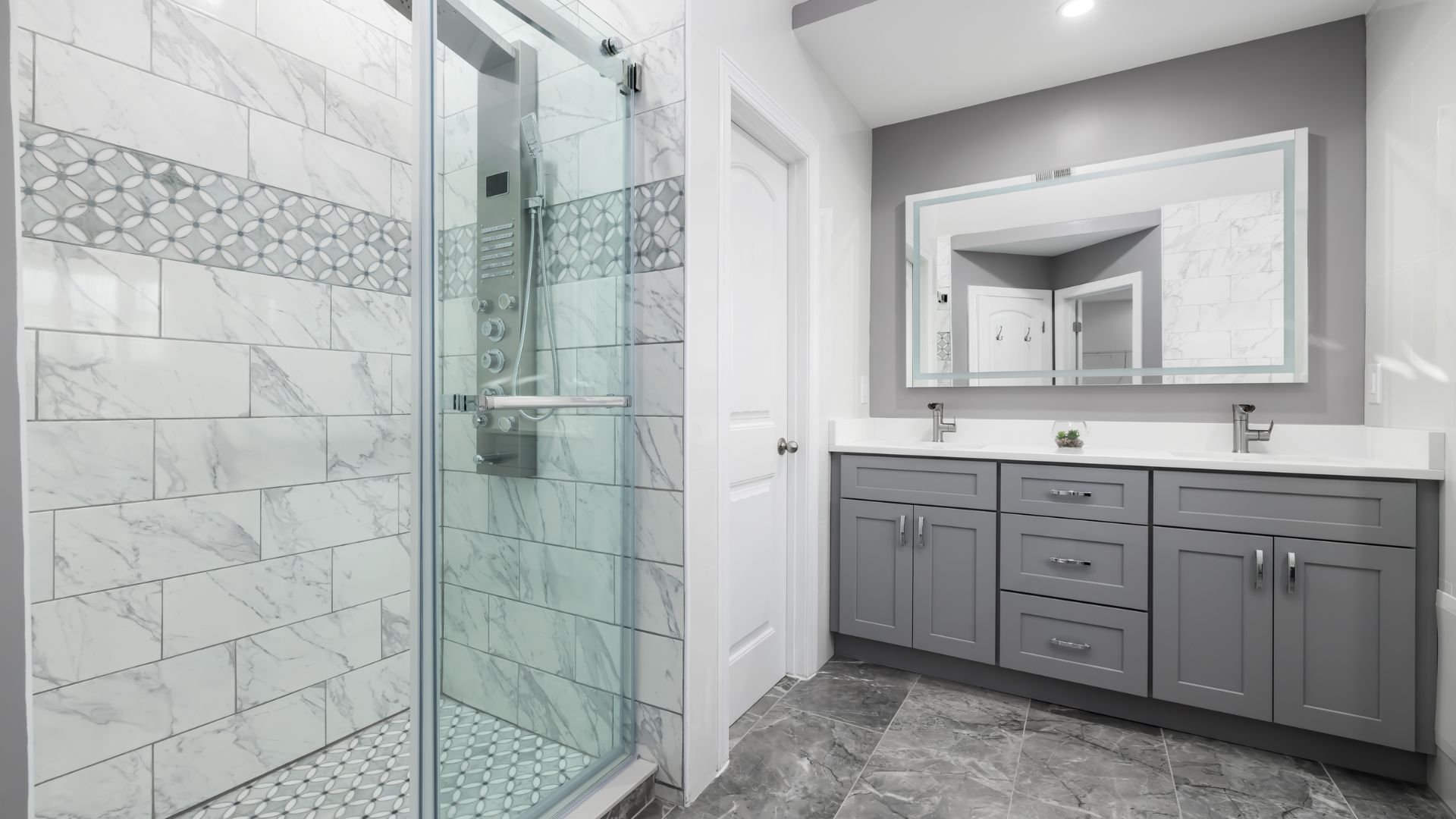 A bathroom with a walk in shower next to a sink