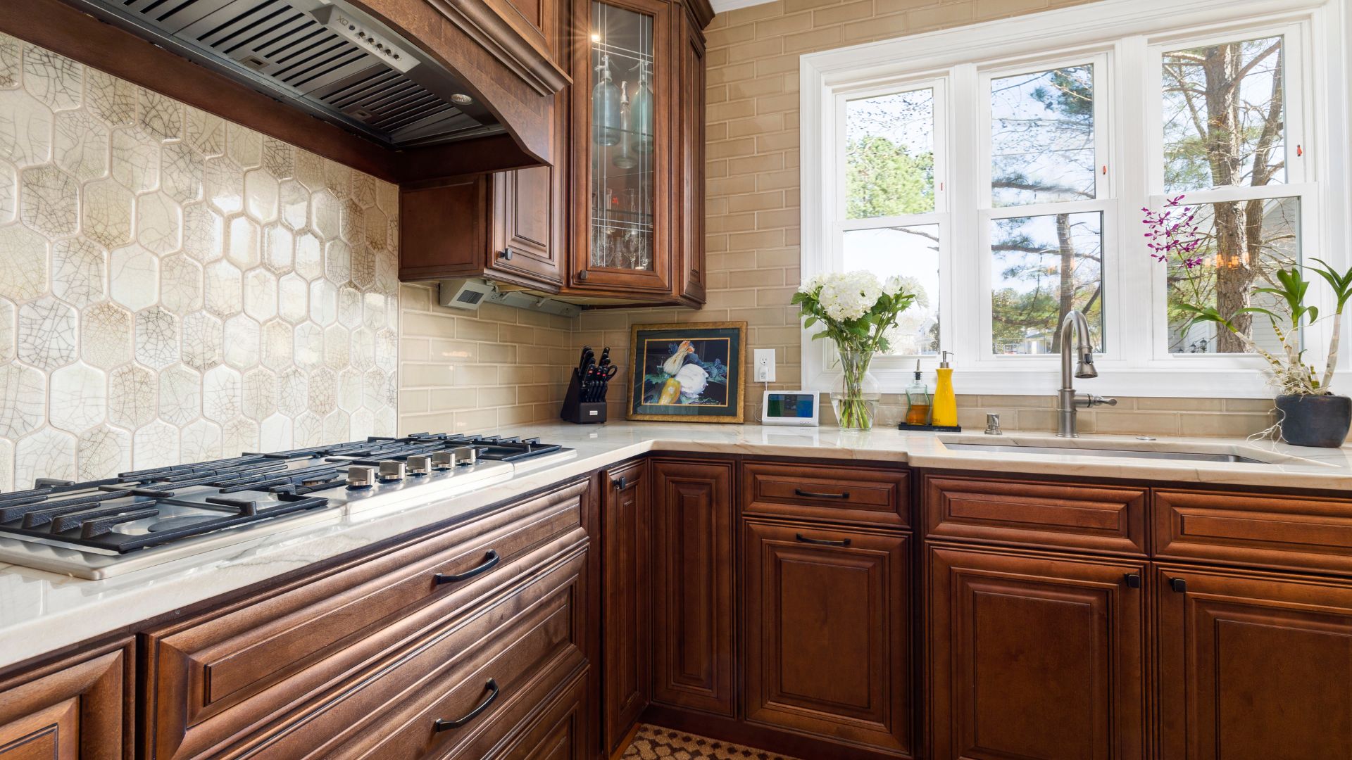 A kitchen with a stove top oven and wooden cabinets