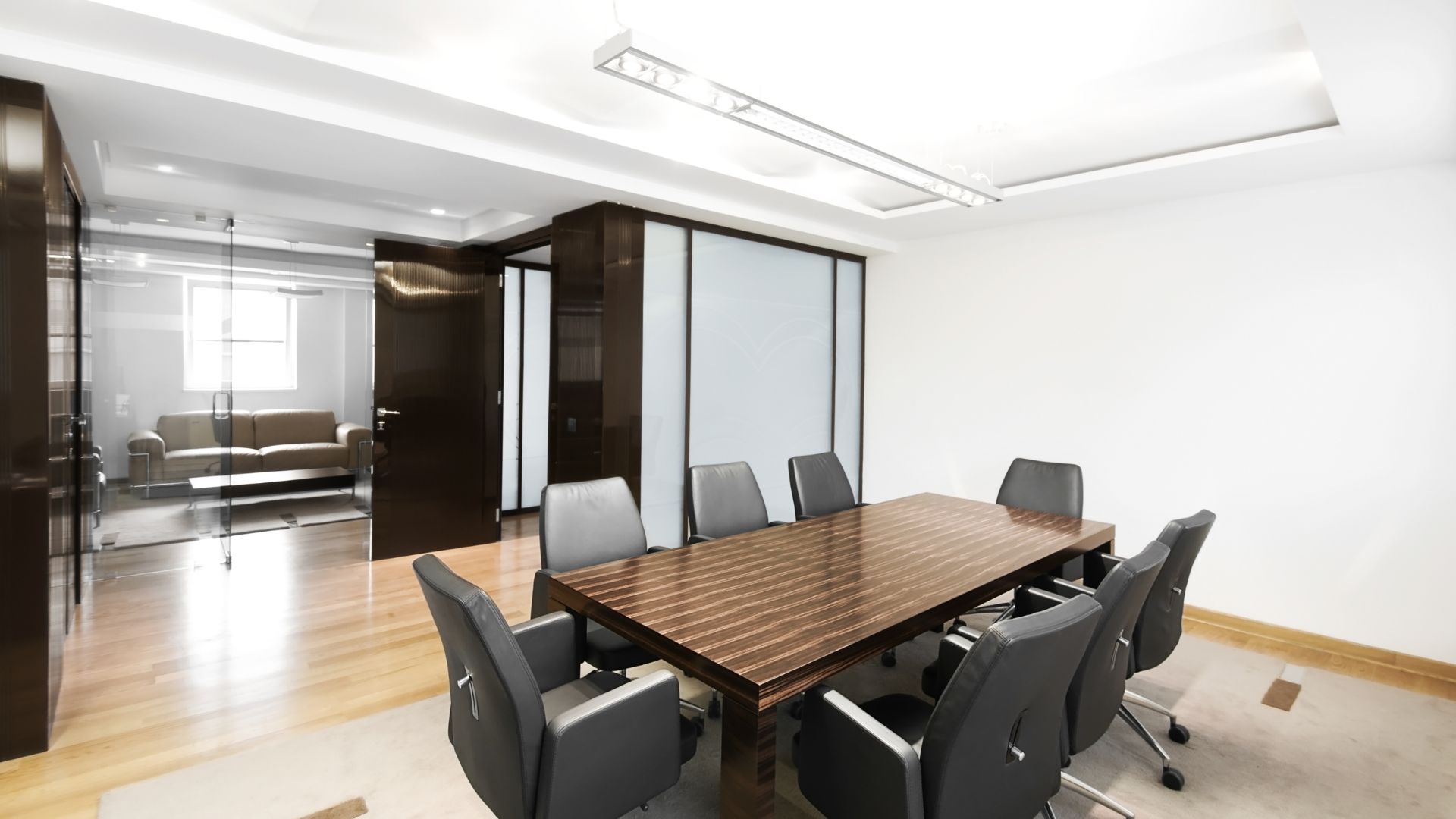 A conference room with a wooden table and chairs